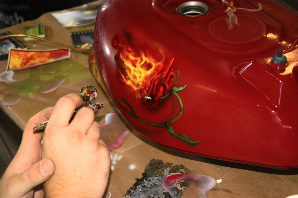 Demonstration at an exhibition. Burning rose on a tank